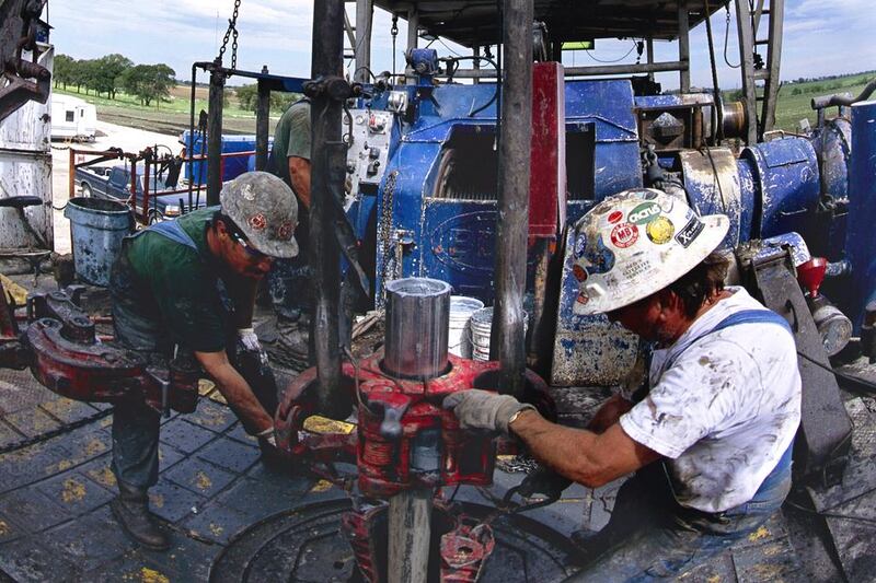 Workers at a Mitchell Energy gas well near Ponder, Texas. George  Mitchell’s company was among the first to yield gas from the US Barnett formation, marking the beginning of the shale age in America.  Greg Smith / Corbis