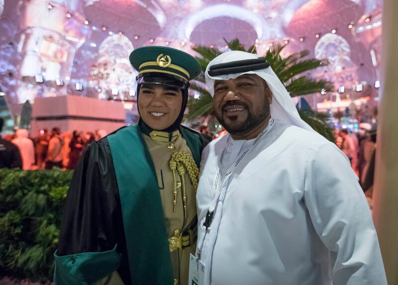 A female graduate is pictured with a family member.