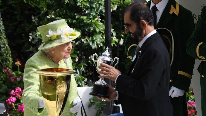 Queen Elizabeth II presents Sheikh Mohammed bin Rashid, Vice President and Ruler of Dubai, with the Diamond Jubilee trophy after Blue Point's victory at Royal Ascot on June 22, 2019. EPA