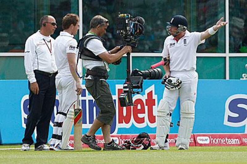 England's Ian Bell, right, reacts after being controversially given out for walking from the pitch.