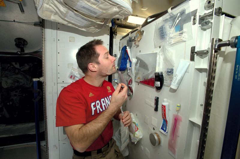 A picture taken on February 12, 2017 and released on February 24, 2017 by ESA/NASA shows French astronaut Thomas Pesquet shaving inside the International Space Station (ISS). - Pesquet posted on social networks a selfie picture on which he shows himself floating into space on January 13, 2017 to the attention of "the supporters of a conspiracy theory who are convinced that he is in a hangar on Earth." (Photo by Handout / ESA/NASA / AFP) / RESTRICTED TO EDITORIAL USE - MANDATORY CREDIT "AFP PHOTO / ESA/NASA" - NO MARKETING NO ADVERTISING CAMPAIGNS - DISTRIBUTED AS A SERVICE TO CLIENTS