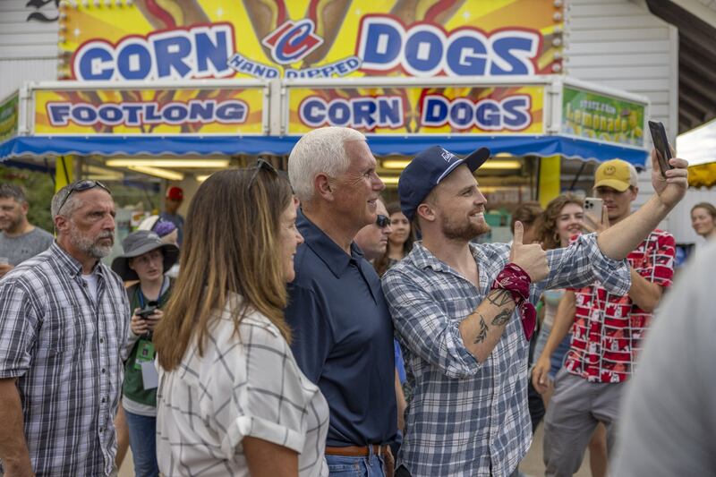 Former US vice president Mike Pence takes a selfie in front of a corn dog stand at the Iowa State Fair in Des Moines, Iowa. Bloomberg