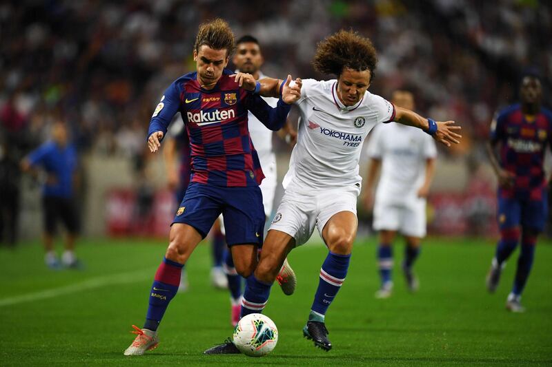 Barcelona forward Antoine Griezmann fights for the ball with Chelsea defender David Luiz. AFP