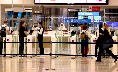 Passengers use the smart passport gates at Dubai International Airport, which help authorities maintain visa records. AFP