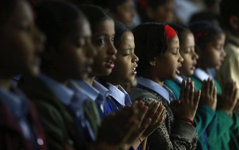 India schoolgirls in Mumbai pray. Rafiq Maqbool / AP Photo