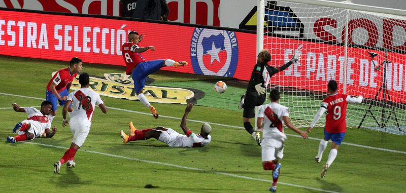 Chile's Arturo Vidal, centre above, scores his side's second goal in their 2-0 victory against Peru during the World Cup qualifier in Santiago on Friday, November 13. AP