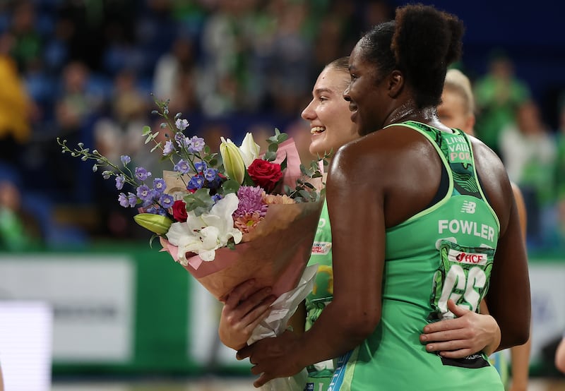 Courtney Bruce of netball team West Coast Fever presents teammate Jhaniele Fowler with a bouquet of flowers for Mother's Day after winning their game against the Collingwood Magpies on May 8, in Perth, Australia. Getty Images