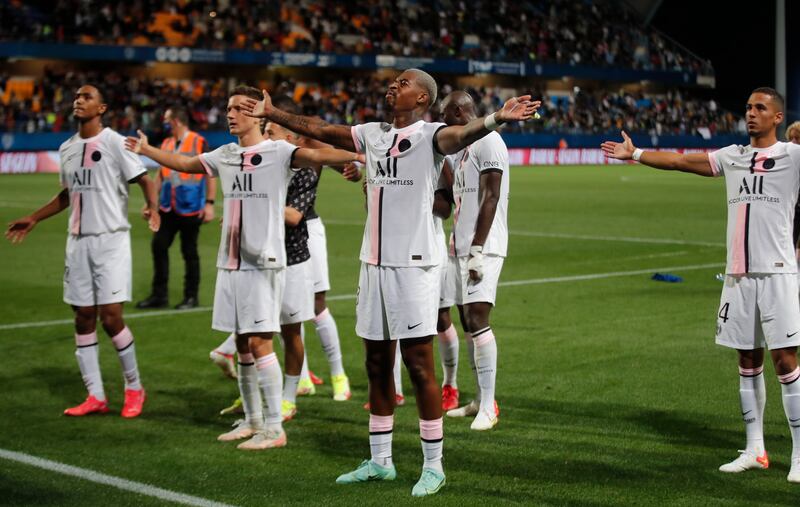 Paris St Germain's Presnel Kimpembe acknowledges the fans with teammates after winning the match.