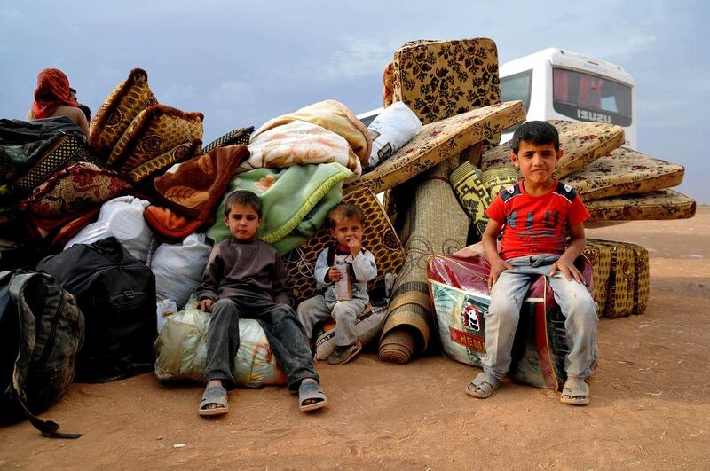 Young Syrian Kurdish refugees enter Turkey at the Yumurtalik crossing gate on September 24. Getty Images