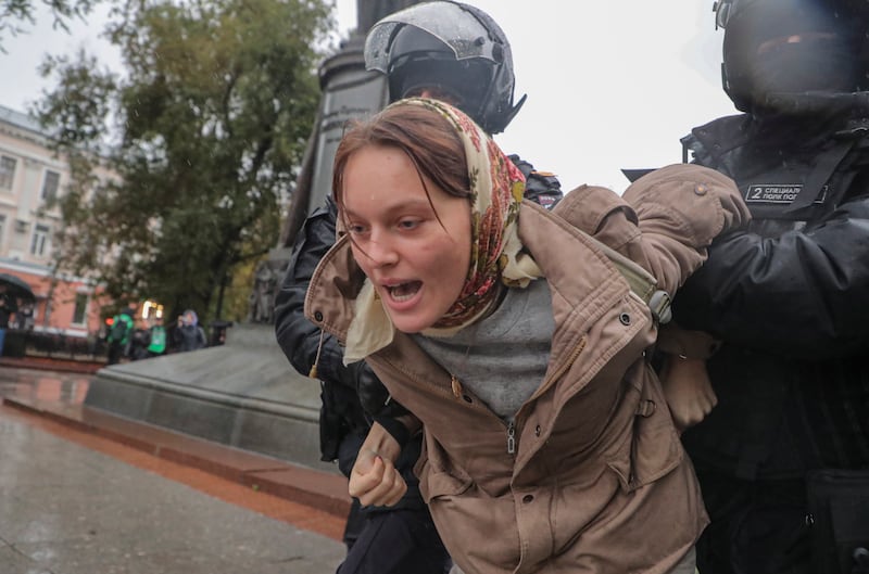 Russian police detain a woman protesting against the country's partial military mobilisation to assist the invasion of Ukraine in central Moscow. EPA 