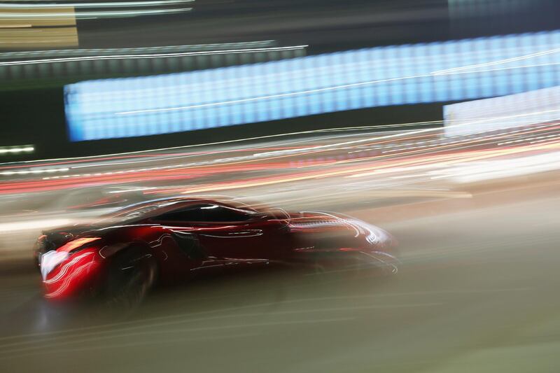 ABU DHABI, UNITED ARAB EMIRATES - FEBRUARY 05: A sports car drives down the Corniche on February 5, 2015 in Abu Dhabi, United Arab Emirates. Abu Dhabi is the capital of the United Arab Emirates and the second most populous city after Dubai with a population of around two million people.  (Photo by Dan Kitwood/Getty Images)