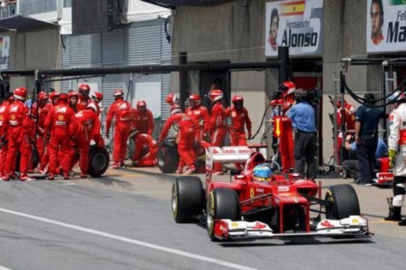 Ferrari Formula One driver Fernando Alonso of Spain drives in the pit lane after performing a pit stop during the Canadian F1 Grand Prix at the Circuit Gilles Villeneuve in Montreal June 10, 2012.  REUTERS/Luca Bruno/Pool (CANADA  - Tags: SPORT MOTORSPORT)  