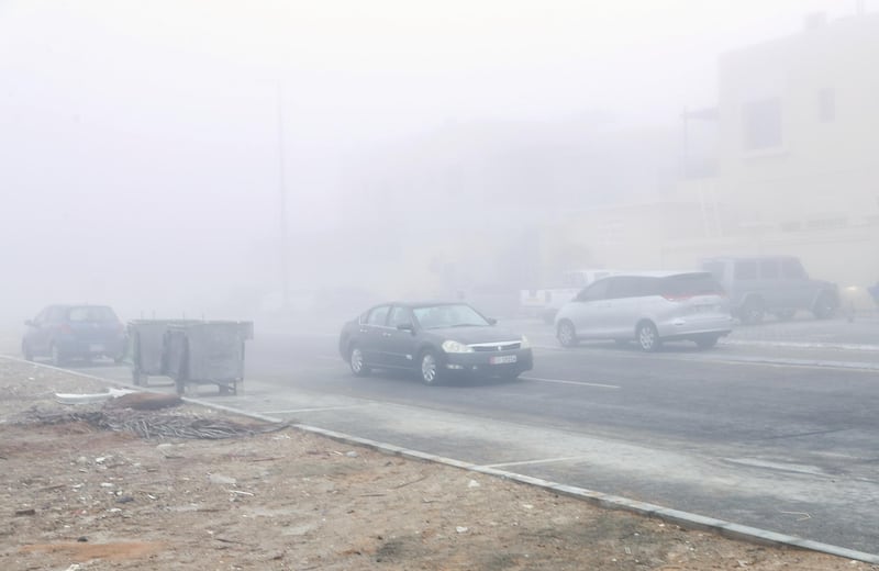 Abu Dhabi, U.A.E., January 15, 2018.  A worker walks through  8 a.m. Khalifa City fog.
Victor Besa / The National
NA