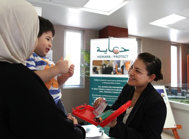 Bunna Eng-Tusitala, burns unit manager at Mafraq Hospital, talks to children about dangers in the home. A study by the hospital found that 90 per cent of burns victims’ parents didn’t know how to treat them. Fatima Al Marzooqi / The National