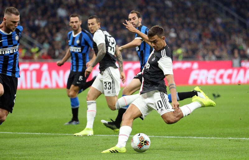 epa07902094 Juventus' Paulo Dybala (R)  scores the 0-1 goal during the Italian serie A soccer match between FC Inter and Juventus FC at Giuseppe Meazza stadium in Milan, Italy, 6 October 2019.  EPA/MATTEO BAZZI
