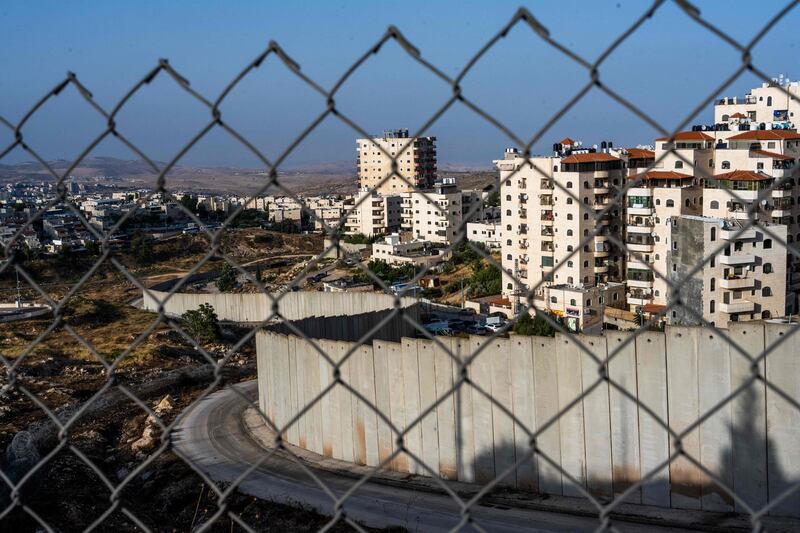 A barrier separating the Israeli settlement of Pisgat Zeev (L) from the eastern part of Jerusalem. AFP