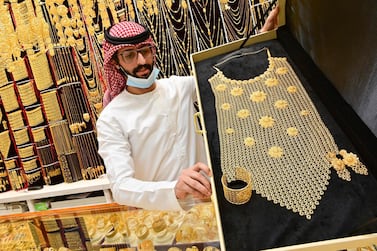 A merchant displays jewellery at his shop in Dubai's Gold Souk. AFP