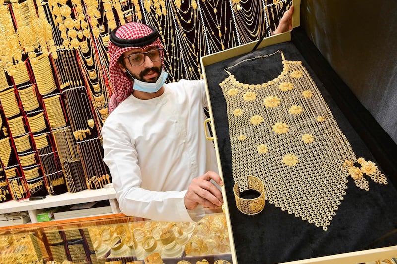 A merchant displays gold jewellery at his shop in Dubai Gold Souk in the Gulf emirate on July 29, 2020.  / AFP / GIUSEPPE CACACE
