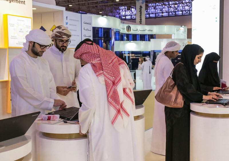 Graduates register their details online at the Sharjah National Career Fair. Victor Besa for The National