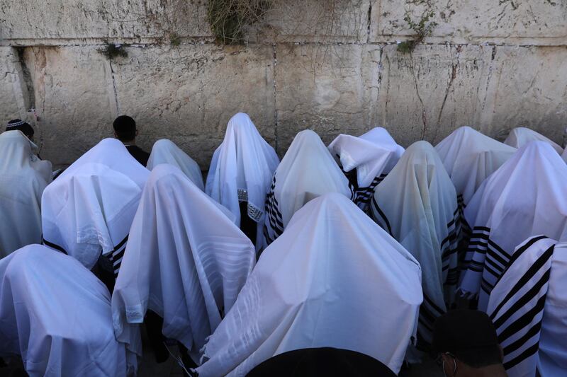 Orthodox Jews cover their heads with prayer shawls as they recite the Priestly Blessing on the high holiday of Passover, in front of the Western Wall, Jerusalem. EPA