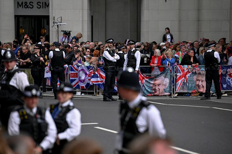 Police officers stand guard as people gather outside St Paul's Cathedral. Reuters