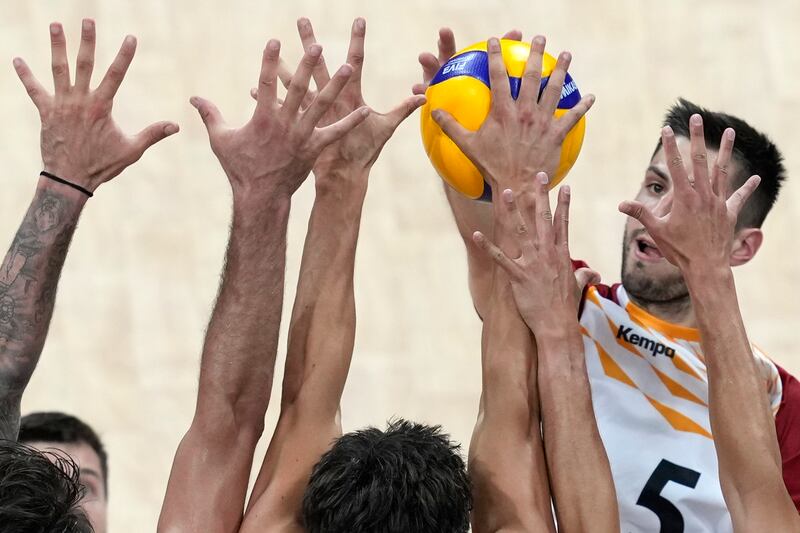 Moritz Reichert of Germany is blocked by players from USA during their Volleyball Men's Nations League match at the Mall of Asia Arena in Manila, Philippines. AP Photo 