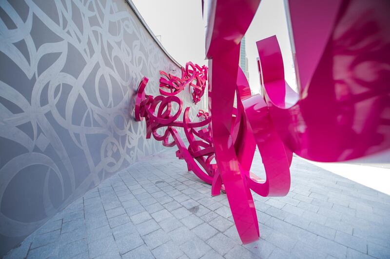 The sculpture is mostly constructed with pink stainless steel.
