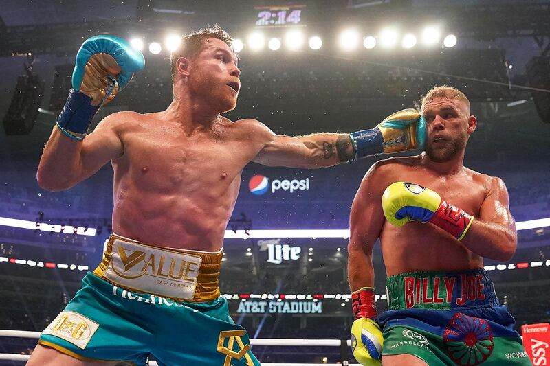 Saul Alvarez lands a left hook on Billy Joe Saunders during their unified super middleweight world title fight. AP