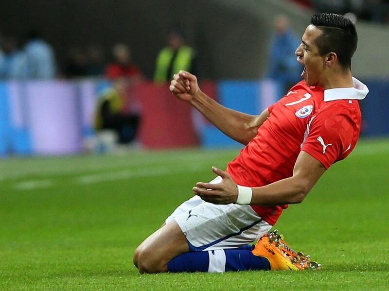 Chile's Alexis Sanchez celebrates after scoring a goal during the international friendly soccer match between England and Chile at Wembley Stadium in London. Alastair Grant / AP Photo