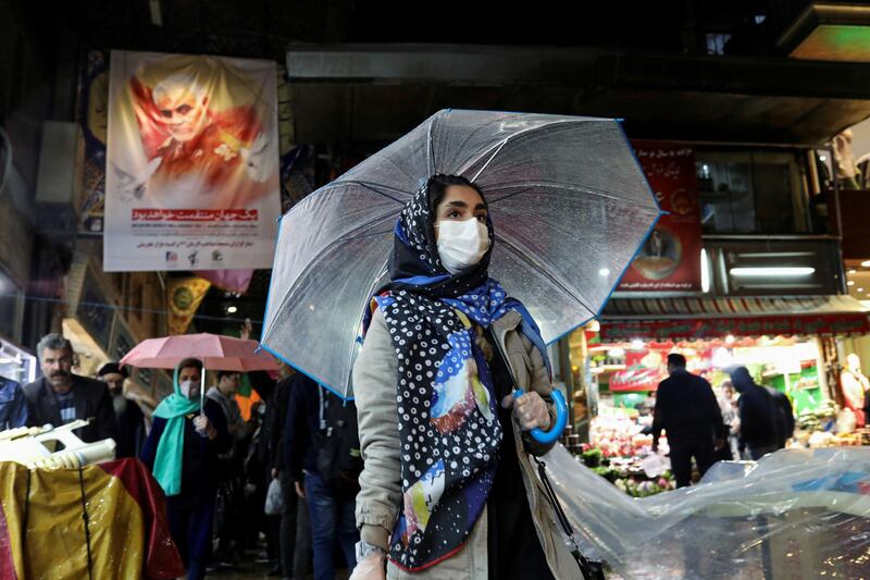 FILE PHOTO: An Iranian woman wears a protective face mask and gloves, amid fear of coronavirus disease (COVID-19), as she walks at Tajrish market, ahead of the Iranian New Year Nowruz, March 20, in Tehran, Iran March 18, 2020. WANA (West Asia News Agency)/Ali Khara via REUTERS ATTENTION EDITORS - THIS PICTURE WAS PROVIDED BY A THIRD PARTY/File Photo