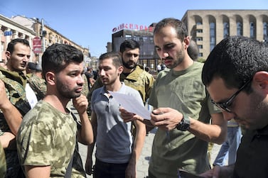 People attend a meeting to recruit military volunteers after Armenian authorities declared martial law and mobilised its male population following clashes with Azerbaijan over the breakaway Nagorno-Karabakh region in Yerevan, Armenia September 27, 2020. Melik Baghdasaryan/Photolure via REUTERS ATTENTION EDITORS - THIS IMAGE HAS BEEN SUPPLIED BY A THIRD PARTY.