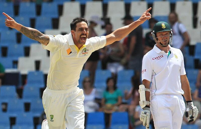 Australia's Mitchell Johnson, left, celebrates a wicket as South Africa captain Graeme Smith watches on Day 4 of the first Test at Centurion Park in Pretoria on Saturday. Themba Hadebe / AP Photo