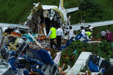 Officials inspect the wreckage of the Air India Express jet at Kozhikode International Airport in Kerala. AFP