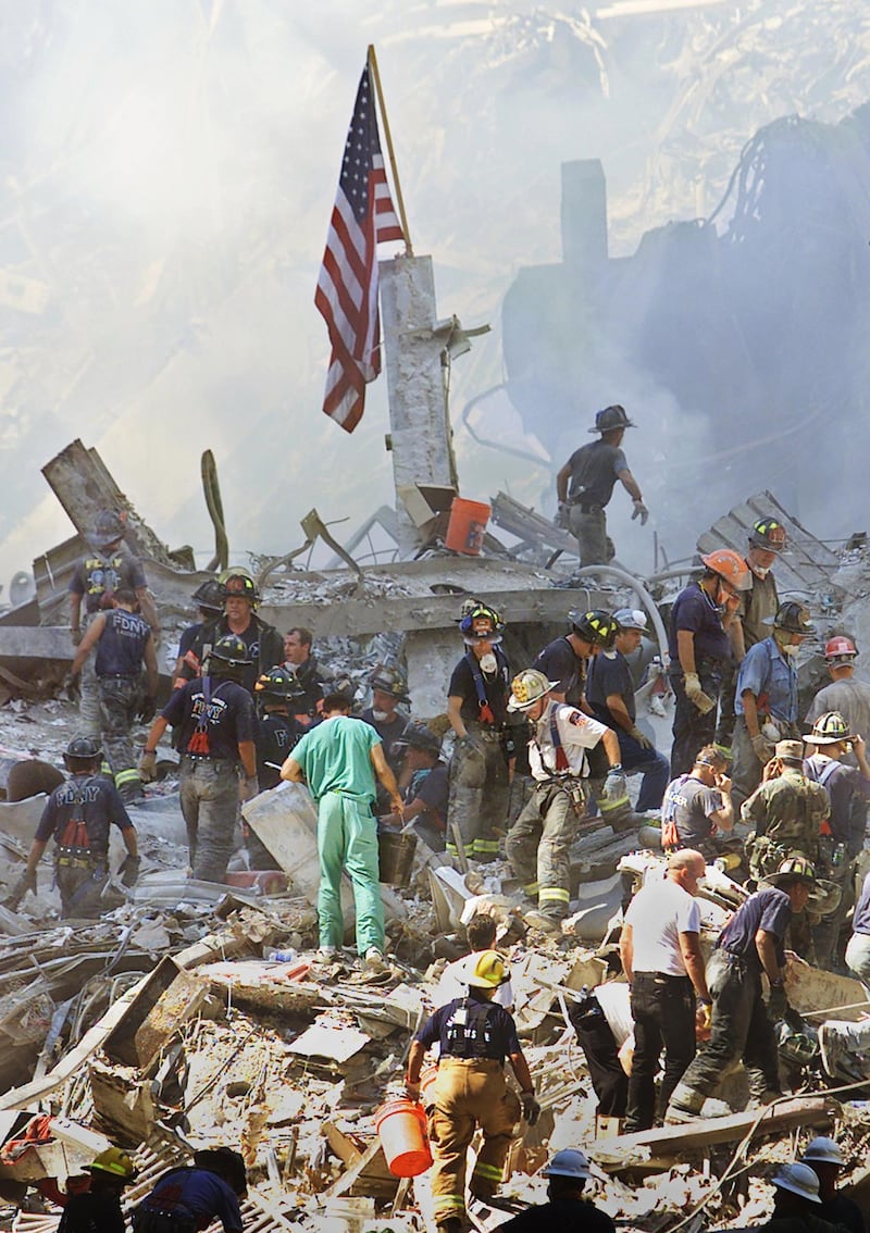 An American flag is posted in the rubble of the World Trade Center 13 September 2001 in New York. The search for survivors and the recovery of the victims continues since the 11 September terrorist attack. AFP PHOTO/Beth A. KEISER (Photo by BETH A. KEISER / AP POOL / AFP)