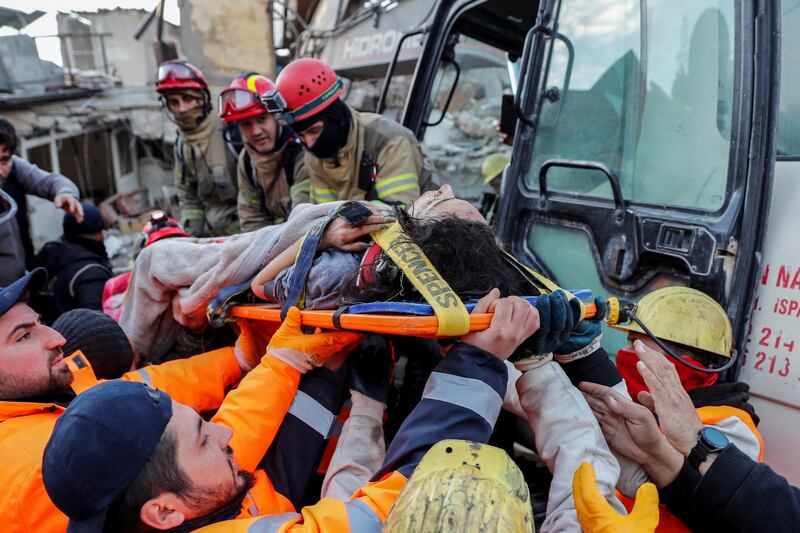 Rescuers carry survivor Rabia Ofkeli, 27, from the rubble in Hatay, southern Turkey. Reuters