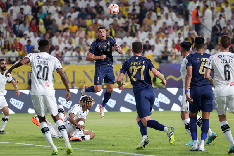 Cristiano Ronaldo leaps for a header against Al Shabab. AFP