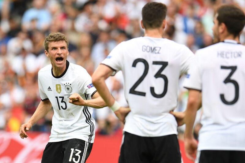 Germany's midfielder Thomas Mueller (L) reacts towards team mates during the Euro 2016 group C football match between Northern Ireland and Germany at the Parc des Princes stadium in Paris on June 21, 2016. / AFP / PATRIK STOLLARZ