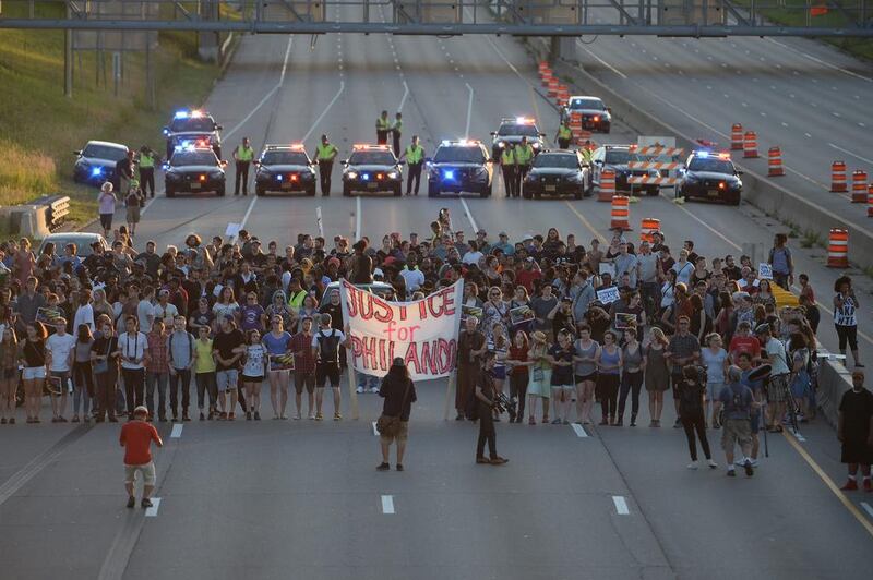 Marchers block part of Interstate 94 in St. Paul, Minnesota, during a protest sparked by the recent police killings of black men in Minnesota and Louisiana. Glen Stubbe / Star Tribune via AP
