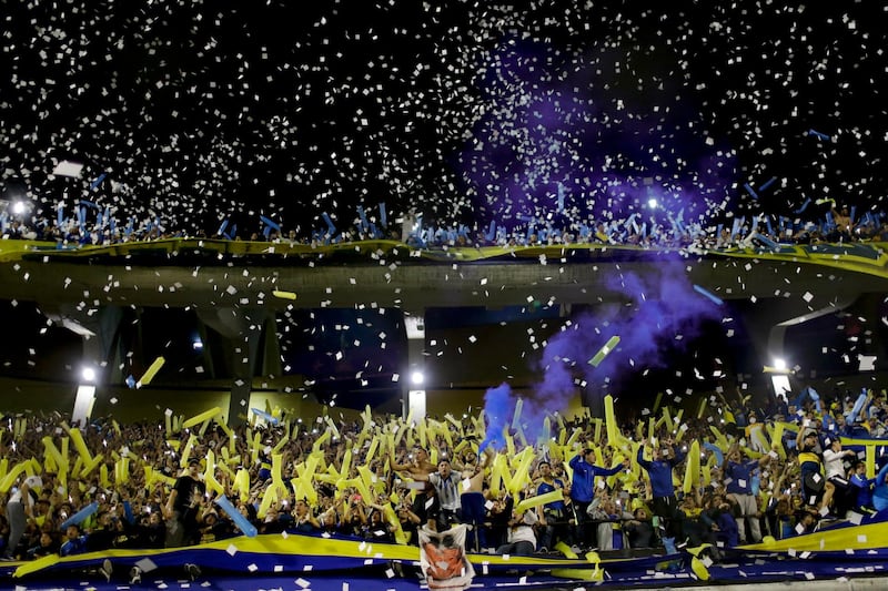 Fans of Boca Juniors cheer amid confetti during the Copa Libertadores semifinal second leg soccer match against River Plate at La Bombonera stadium in Buenos Aires, Argentina, Tuesday, Oct. 22, 2019. (AP Photo/Natacha Pisarenko)