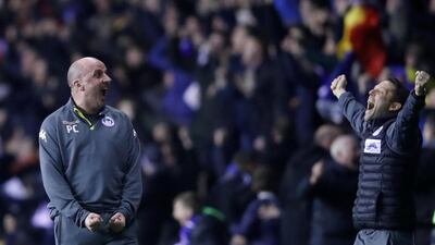 Wigan Athletic manager Paul Cook and his assistant Leam Richardson celebrate Will Grigg's match-winning goal. Carl Recine / Reuters