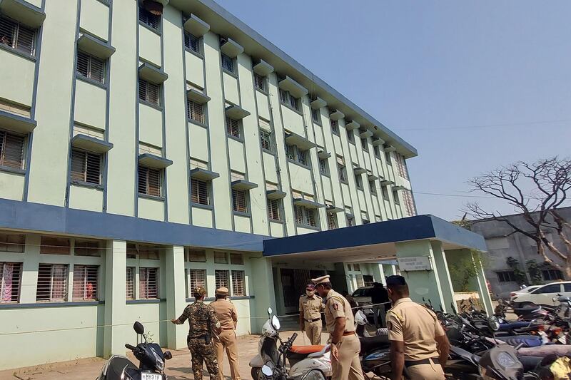 Police personnel stand outside the maternity unit of district general hospital at Bhandara. AFP