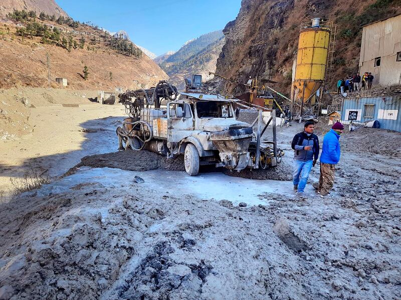 People inspect the site near the damaged Dhauli Ganga hydropower project at Reni village in the Chamoli district of Uttarakhand, India. AP