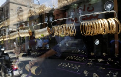 A salesman arranges gold jewellery in a shop at the market of Khan El Khalili in Old Cairo. Reuters 