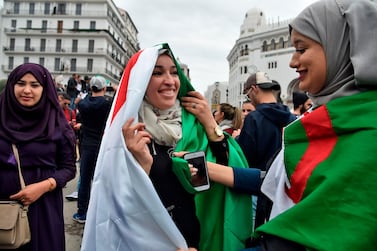Algerian female protesters wear their national flags. AFP