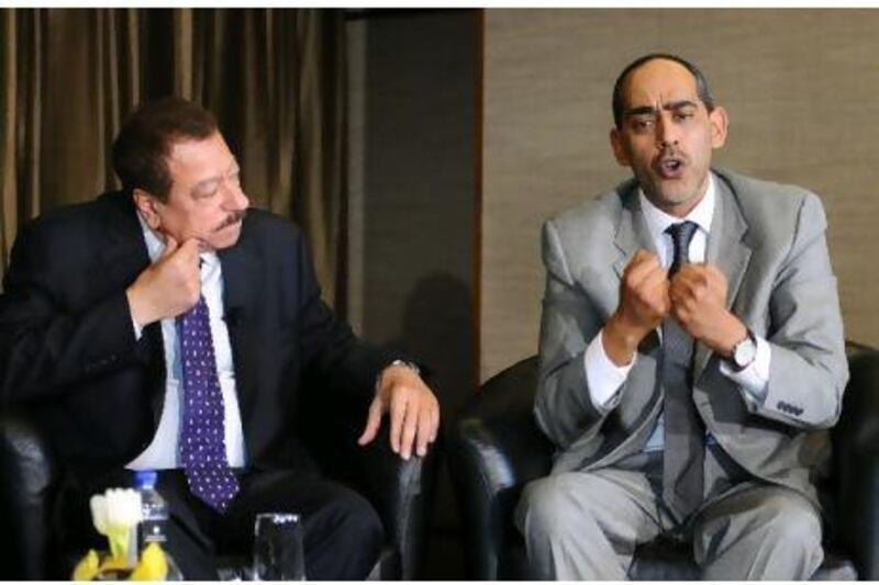 Tarek Yousef, right, the founding dean of the Dubai School of Government, holds forth at Tuesday's debate as Abdel Bari Atwan, the editor-in-chief of Al-Quds Al-Arabi newspaper, listens.