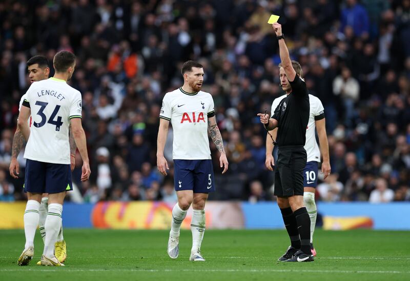 Referee John Brooks shows a yellow card to Spurs defender Clement Lenglet. Getty
