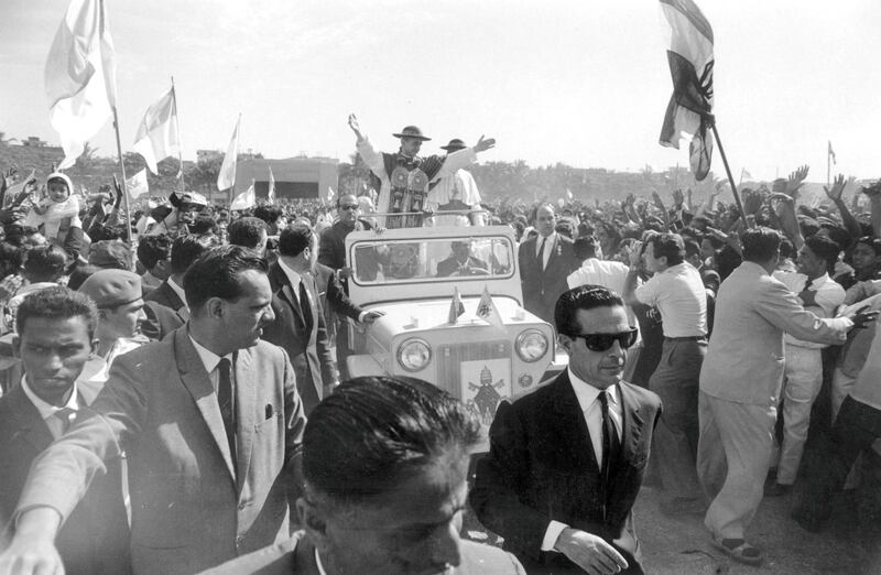 5th December 1964:  During a visit to the John Bosco School in India, Pope Paul VI drives through the crowds with a convoy of bodyguards.  (Photo by Terry Fincher/Express/Getty Images)
