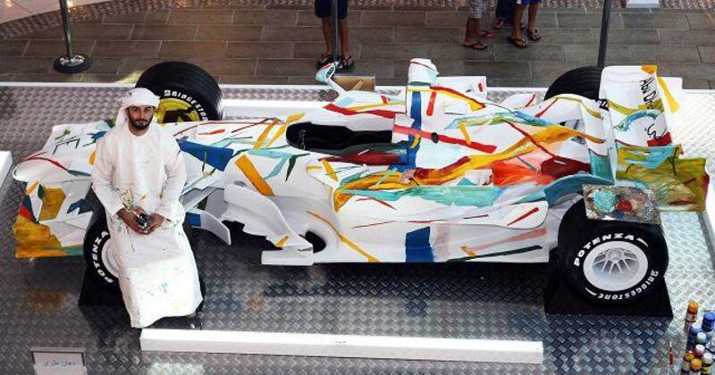 Wasel Safwan with the full-size replica of an F1 car at Marina Mall.