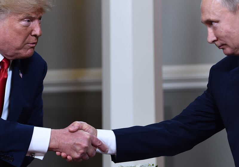 (FILES) In this file photo taken on July 16, 2018, US President Donald Trump (L) and Russian President Vladimir Putin shake hands ahead a meeting in Helsinki. A long-awaited US probe on Russian election meddling has divided Washington but on one point virtually all US policymakers are clear -- there will be no reconciliation with Moscow. The 400-page document by Special Counsel Robert Mueller laid out Russia's persistent efforts to tilt the 2016 presidential election to Donald Trump, although it did not find that his campaign was colluding with Russia.  / AFP / Brendan Smialowski
