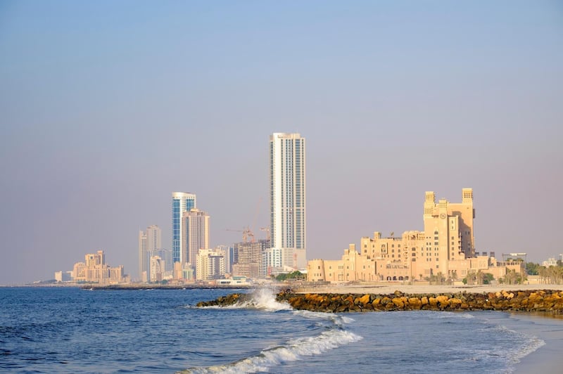 F4RGH6 View of skyline along corniche waterfront of  Ajman emirate in United Arab Emirates. Alamy